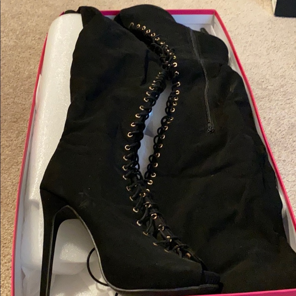 Thigh high lace up boots.